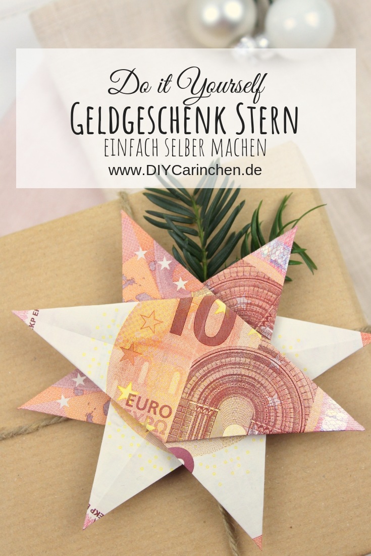 Origami Stern mit 10 Euro Scheinen auf einem Geschenk